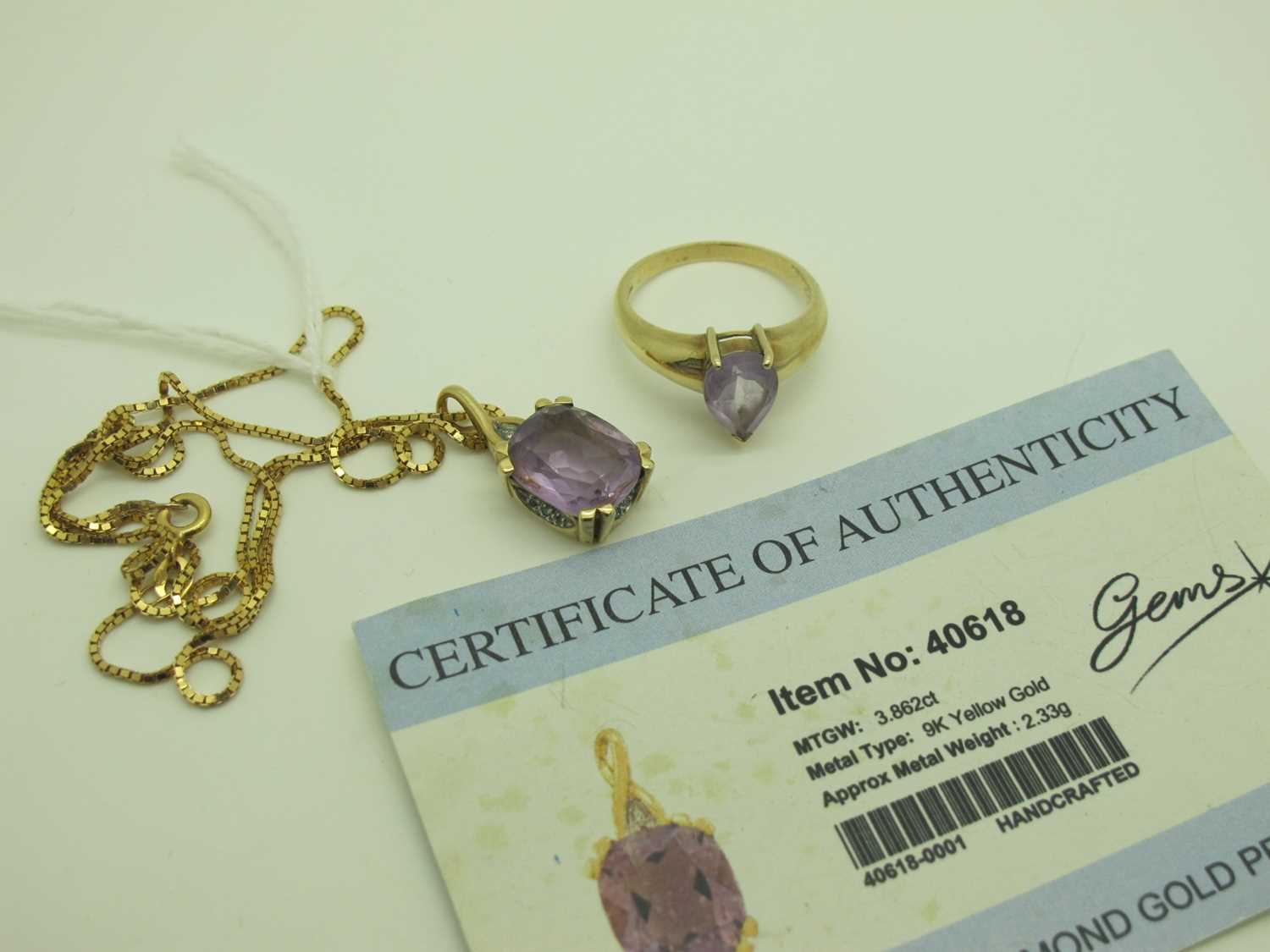 Lot 207 - A Modern Amethyst and Diamond Pendant, claw...