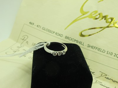 Lot 333 - A Modern Three Stone Diamond Ring, the...