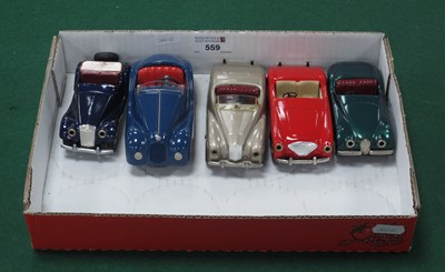 Lot 559 - Four Mid XX Century 'Push 'N' Go Tinplate Cars,...