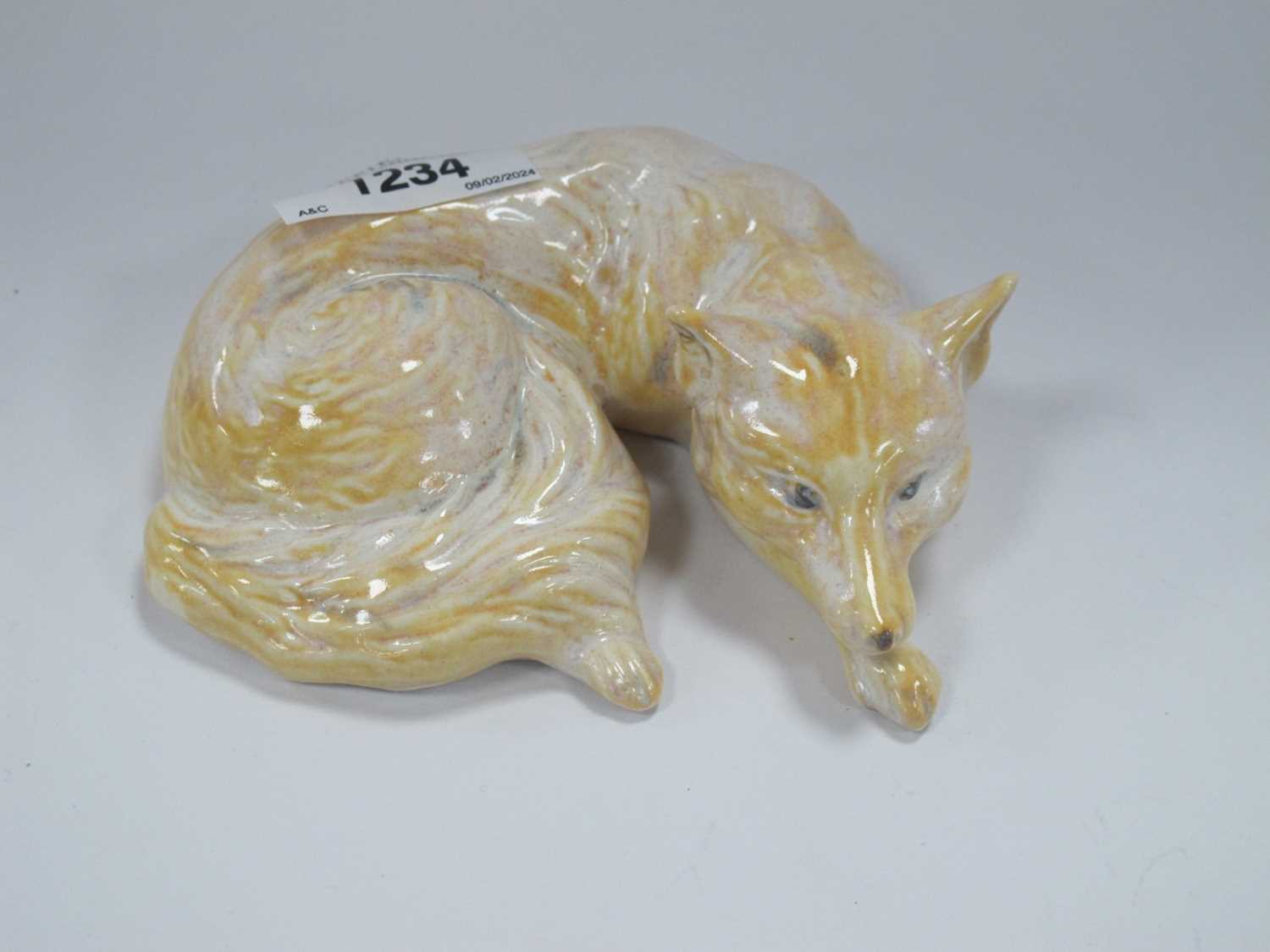 Lot 1234 - Anita Harris Model of a Curled Fox, gold signed.