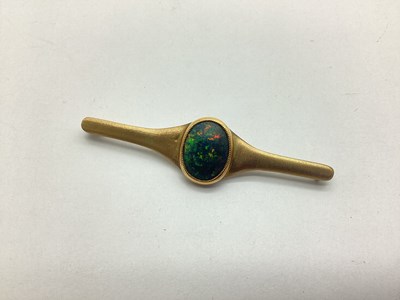 Lot 206 - A Black Opal (Doublet?) Set Bar Brooch, oval...