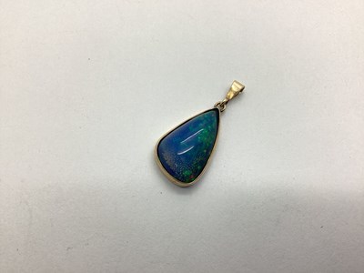 Lot 209 - A Black Opal (Doublet?) Pendant, irregular...