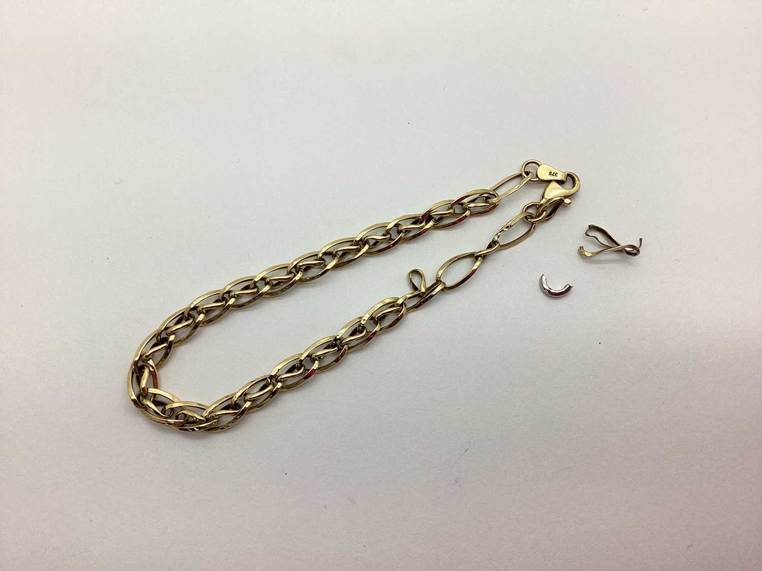 Lot 186 - A Fancy Link Bracelet, (damaged) stamped "375"...