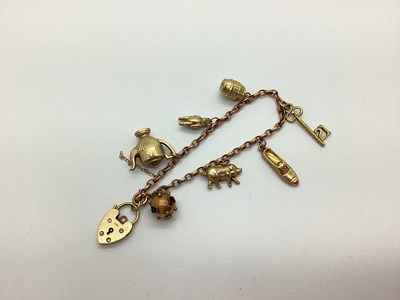 Lot 201 - A Charm Bracelet, suspending assorted charm...