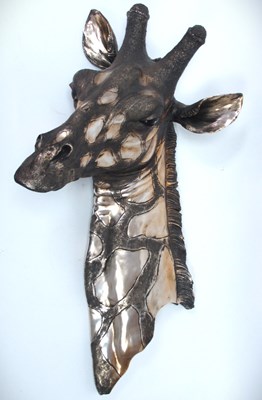 Lot 1368 - A large painted resin wall mounted Giraffe...