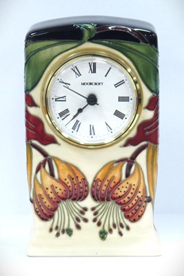Lot 1181 - A Moorcroft clock decorated in the 'Anna Lily'...