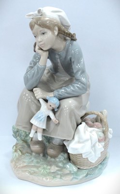 Lot 1253 - Lladro figure of a small girl holding a doll...