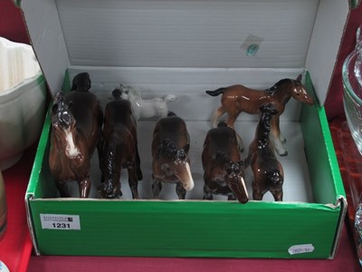 Lot 1231 - Four Beswick Foals, in brown and grey gloss,...