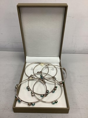 Lot 166 - A Set of Four Modern Indian Collet Set Bangles,...