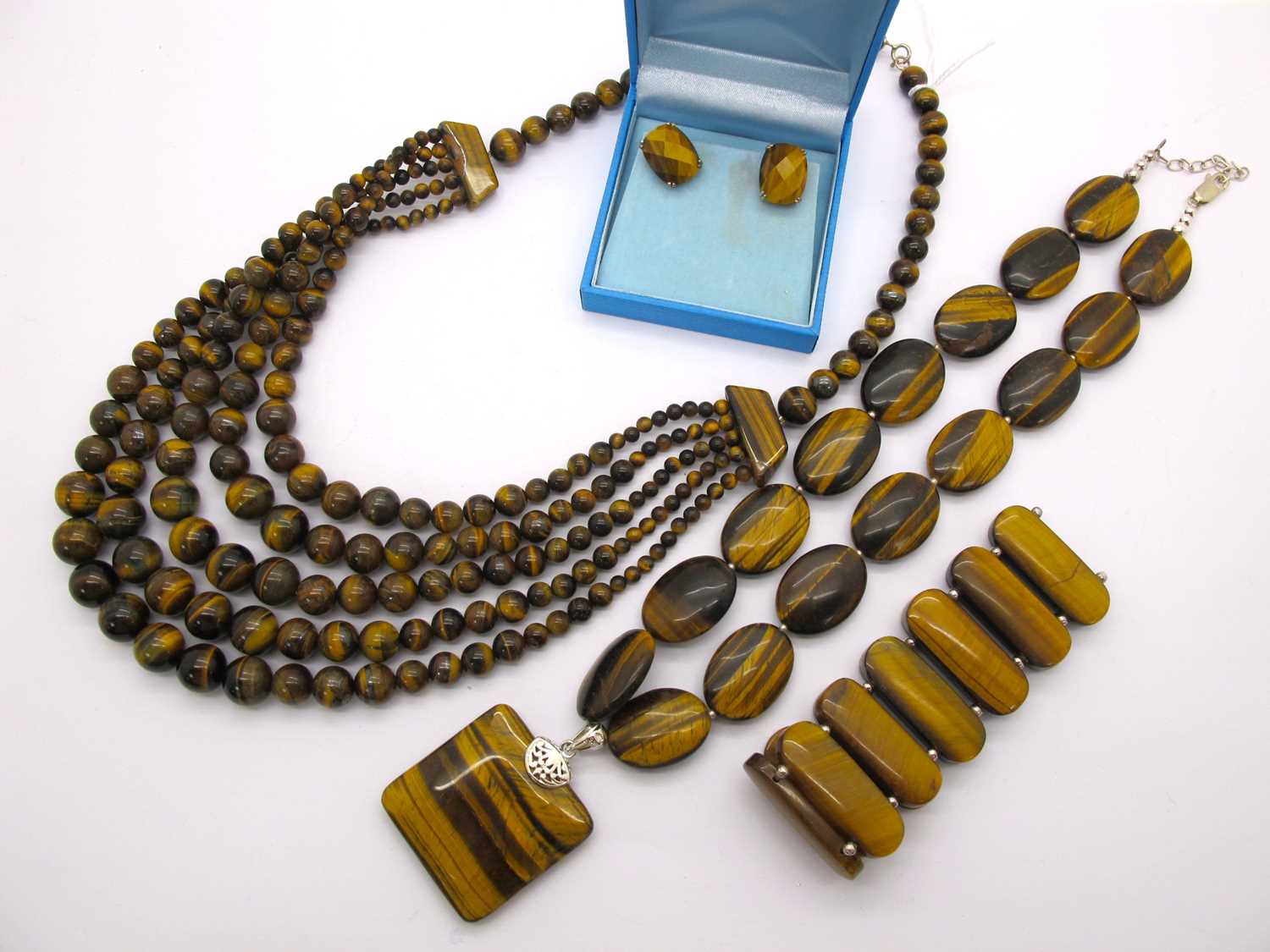 Lot 21 - A Modern Tiger's Eye Polished Flat Bead...