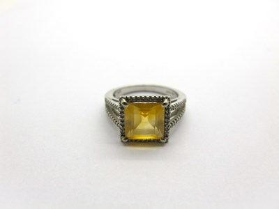 Lot 207 - A Claw Set Dress Ring, set between tapered...