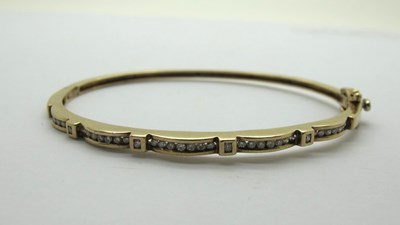 Lot 207 - A Modern 9ct Gold Diamond Set Hinged Bangle,...