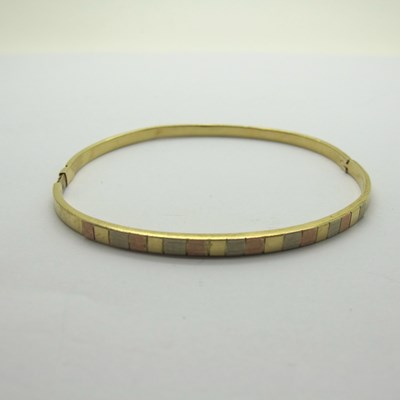 Lot 191 - A Modern Hinged Bangle, of tri colour design...