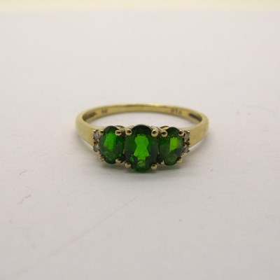 Lot 212 - A Modern Diopside Three Stone Dress Ring, with...