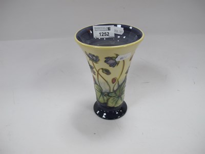 Lot 1252 - Moorcroft Pottery Vase, featuring violets on...