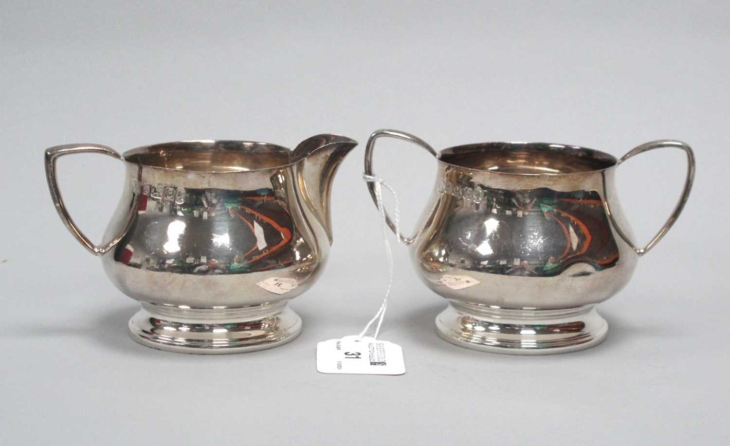 Lot 31 - A Hallmarked Silver Jug and Matching Twin...