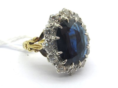 Lot 196 - A Large Oval Sapphire and Diamond Cluster Ring,...