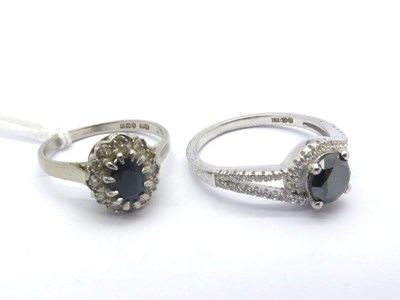 Lot 185 - A Platinum Cluster Dress Ring, oval claw set...