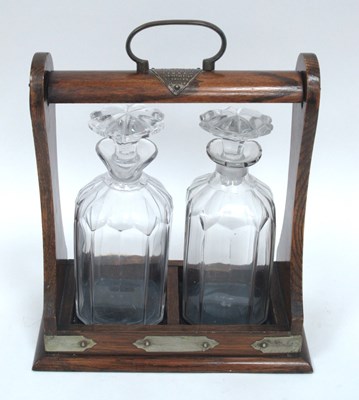 Lot 1270 - An Early XX Century Two Bottle Tantalus, in an...