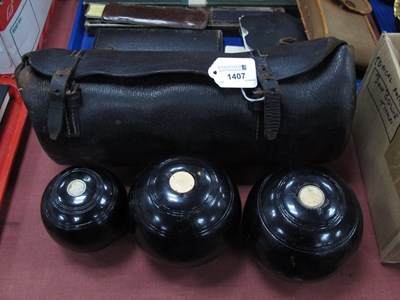 Lot 1407 - A set of three garden bowls in case, two large...