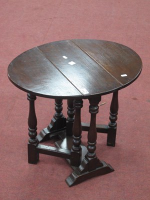 Lot 1546 - An Oak Occasional Table, with drop leaves on...