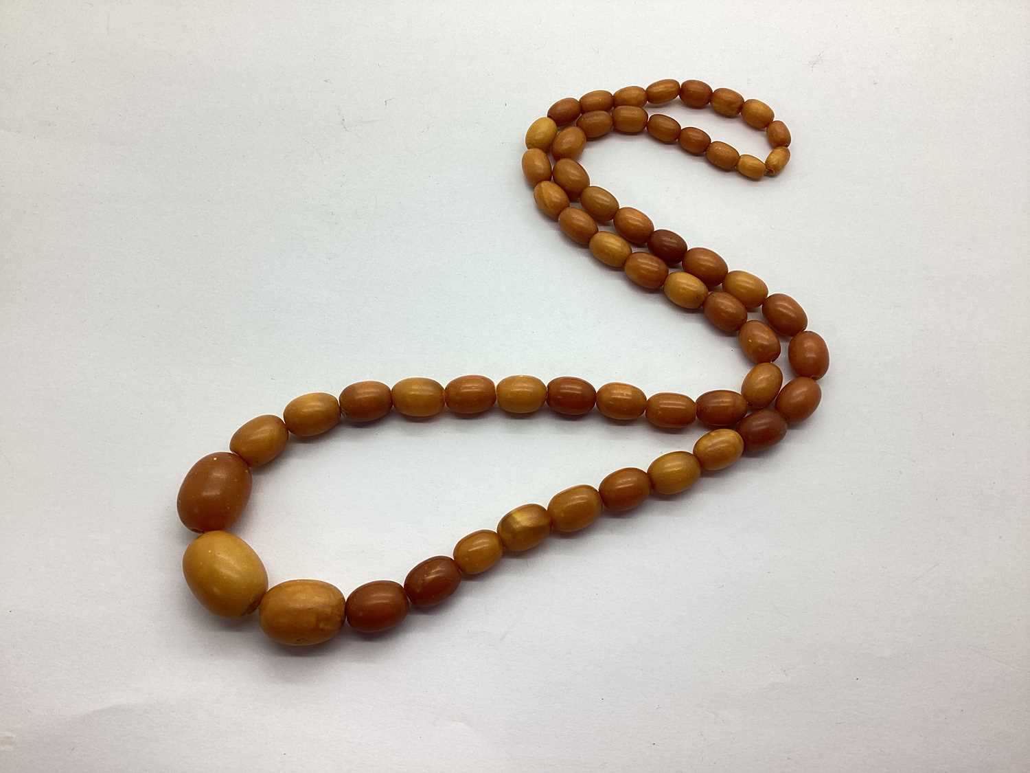 Lot 197 - An Amber Coloured Graduated Single Strand Bead...