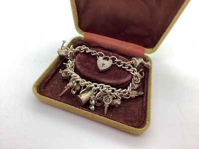 Lot 208 - A Curb Link Charm Bracelet, to heart shape...