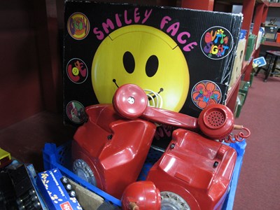 Lot 1023 - Two Red Plastic Anvil Telephones, Smiley Face...