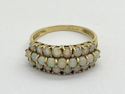 Lot 318 - A 9ct Gold Stone Set Dress Ring, of three row...