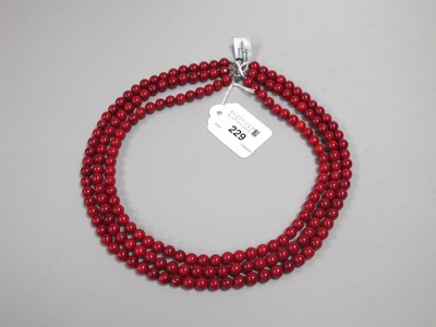 Lot 229 - A Modern Red Coral Three Row Necklace, uniform...