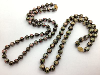 Lot 248 - A Cloisonné Bead Necklace, floral on a black...