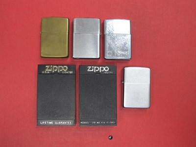 Lot 1303 - Six Zippo Lighters, including Courageous,...