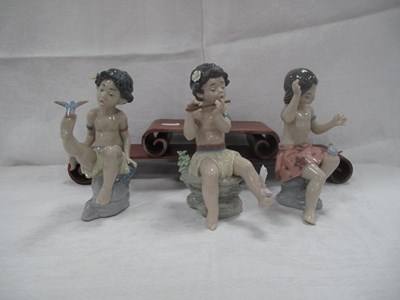 Lot 1289 - Three Lladro Figures of Hawaiian Children, boy...