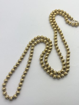 Lot 296 - Trifari; A Gilt Metal Bead Long Necklace, 82cm.