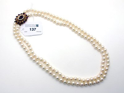 Lot 137 - A Two Row Uniform Pearl Bead Necklace, knotted,...