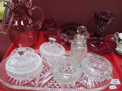 Lot 1221 - A XIX century cranberry glass jug with a wavy...