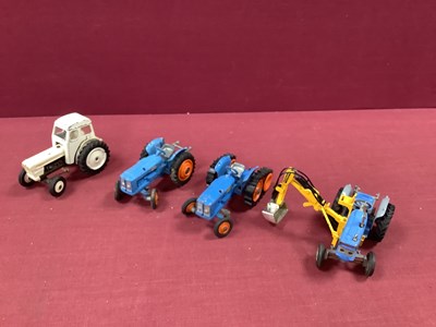 Lot 643 - Four Diecast Tractors by Corgi and Dinky,...