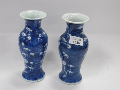 Lot 1335 - A pair of Chinese blue and white prunus vases...