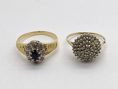 Lot 341 - A Sapphire and Diamond Cluster Ring, oval claw...