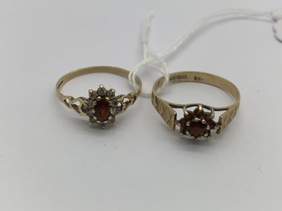 Lot 133 - A 9ct Gold Floral Cluster Ring, set between...