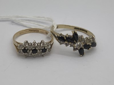 Lot 103 - A 9ct Gold Triple Floral Cluster Ring, between...