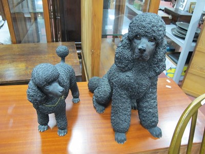 Lot 1165 - Two Leonardo Black Poodle Figures, the tallest...