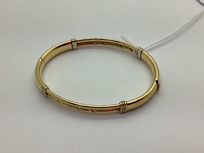 Lot 156 - A Modern Bangle, oval, of textured finish with...