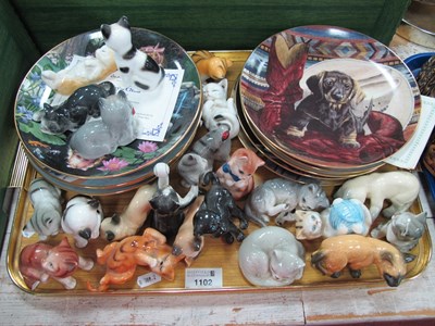 Lot 1102 - A Collection of Pottery Cat Figures, in...