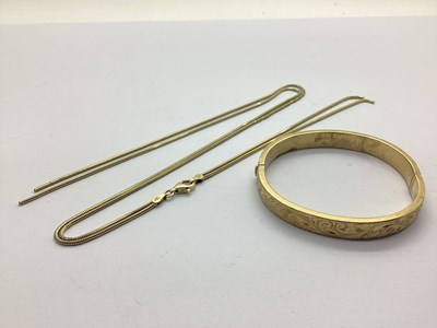 Lot 215 - A Hollow Hinged Bangle, (dents) hinged to snap...