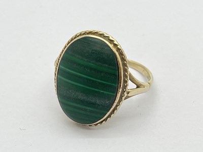 Lot 163 - A Malachite Oval Panel Ring, collet set,...