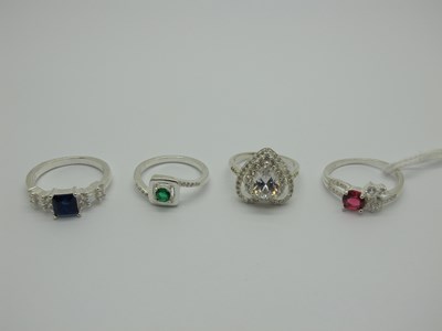 Lot 543 - Four Modern Dress Rings, claw set, stamped...