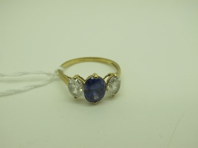 Lot 215 - A Modern QVC Three Stone Dress Ring, oval claw...