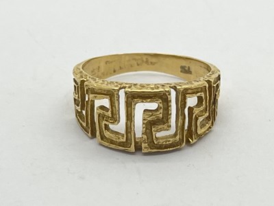 Lot 171 - A Textured Greek Key Scroll Ring, between...