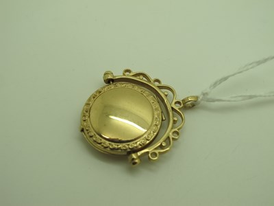 Lot 155 - A 9ct Gold Swivel Locket Pendant, with scroll...